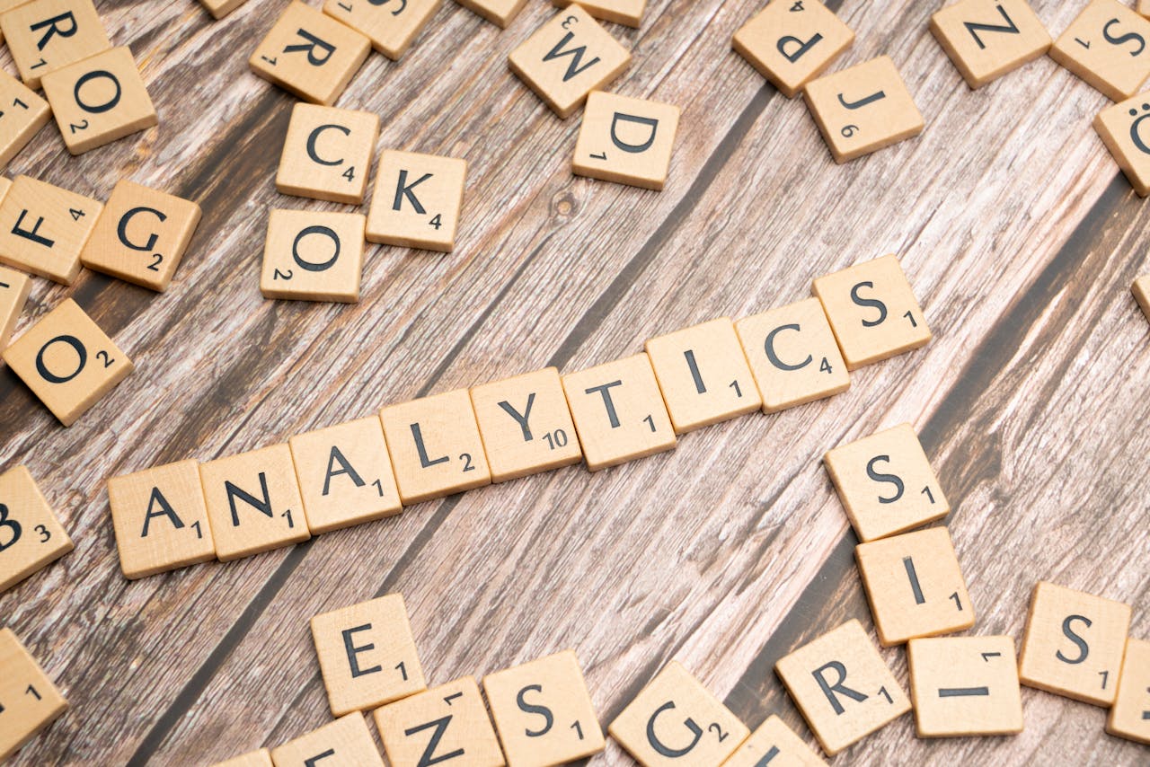 gallery-05 Scrabble tiles spelling 'Analytics' on a wooden surface, symbolizing data analytics concept.